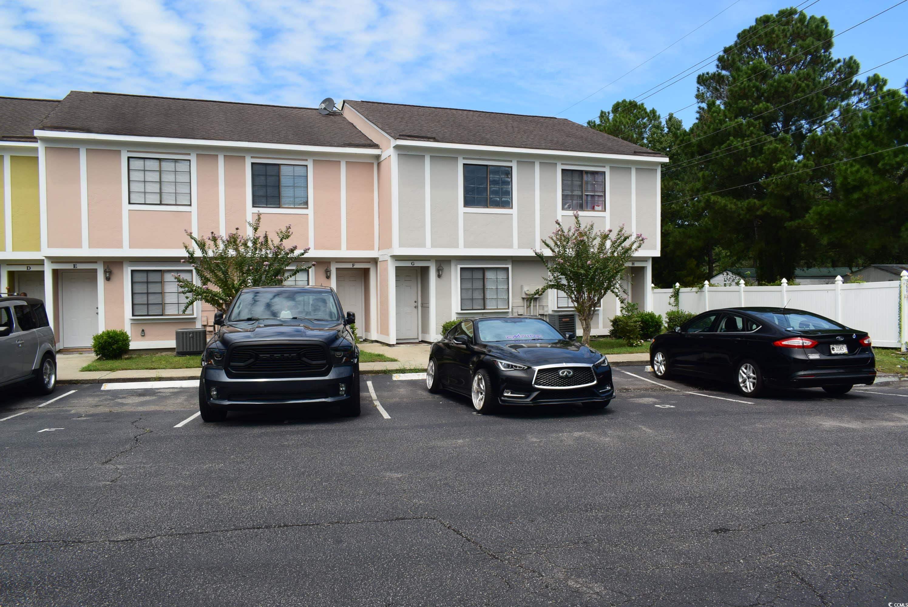1208 Pinegrove Drive, Unit G Myrtle Beach, SC 29577 - Photo 11 of 15 View of front of home with stucco siding, uncovered parking, and roof with shingles