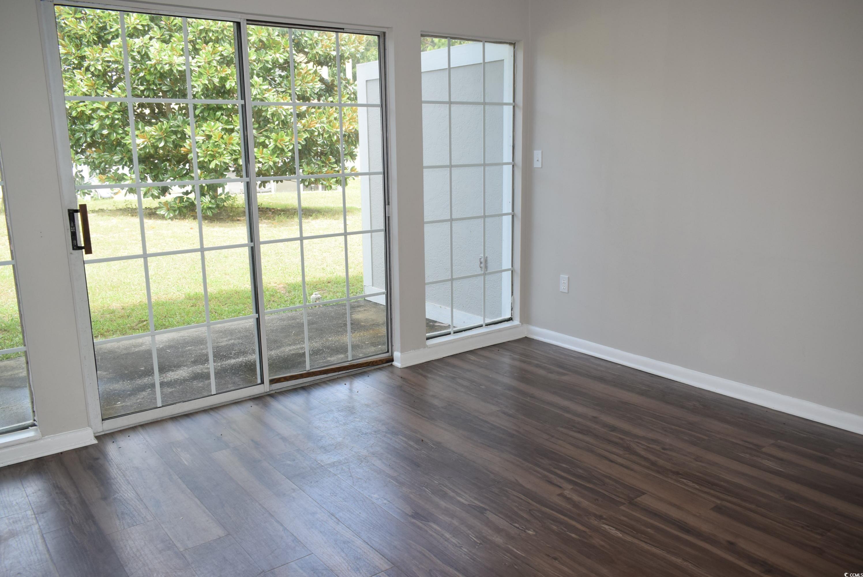 1208 Pinegrove Drive, Unit G Myrtle Beach, SC 29577 - Photo 2 of 15 Unfurnished room featuring dark wood finished floors and baseboards