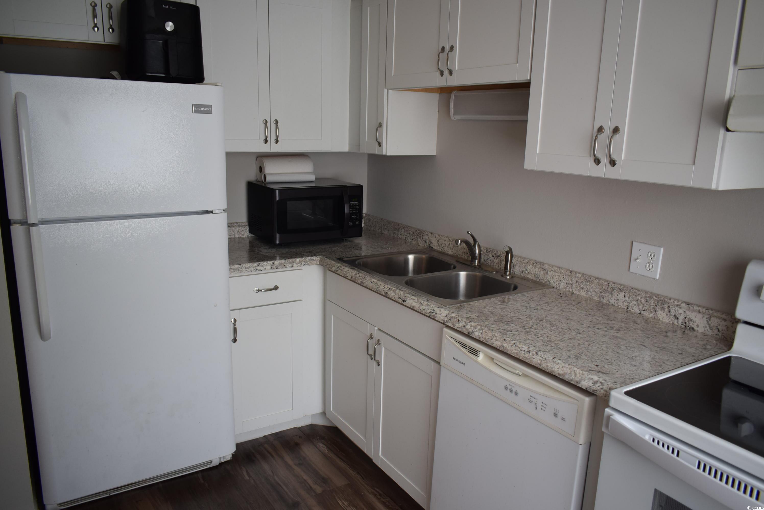 1208 Pinegrove Drive, Unit G Myrtle Beach, SC 29577 - Photo 3 of 15 Kitchen featuring white appliances, white cabinets, and light countertops