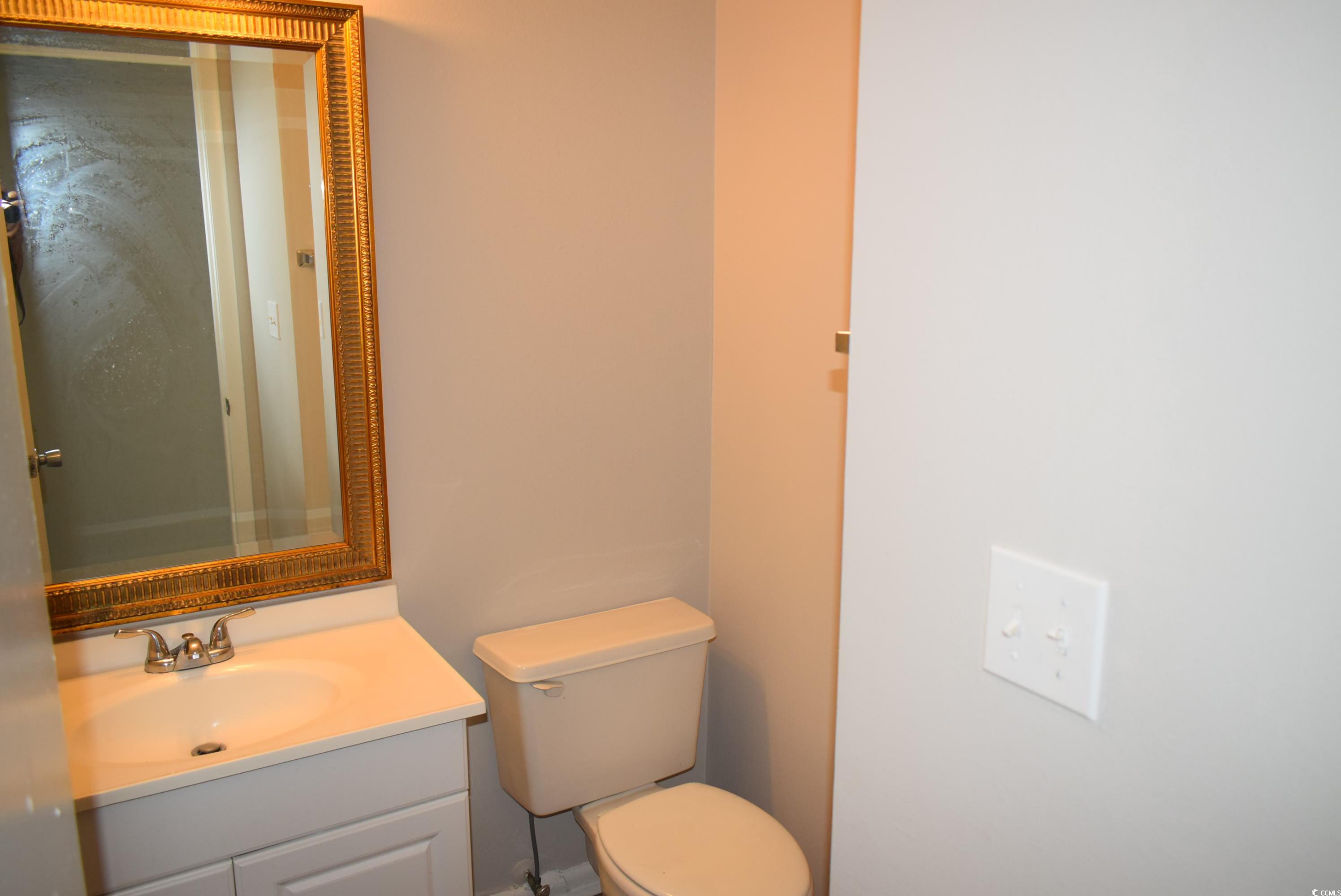 1208 Pinegrove Drive, Unit G Myrtle Beach, SC 29577 - Photo 4 of 15 Half bathroom with vanity and toilet