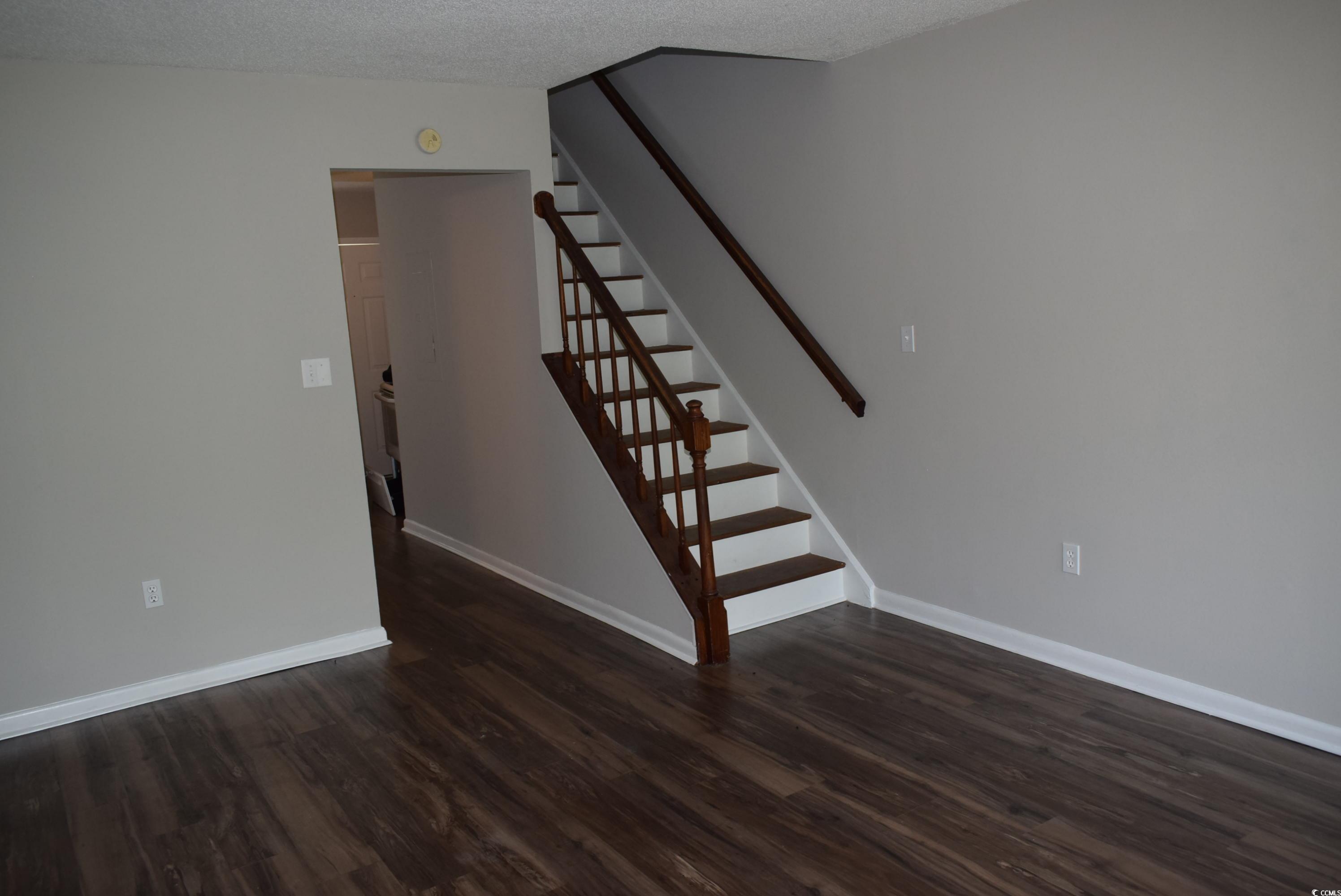 1208 Pinegrove Drive, Unit G Myrtle Beach, SC 29577 - Photo 5 of 15 Staircase with wood finished floors and a textured ceiling