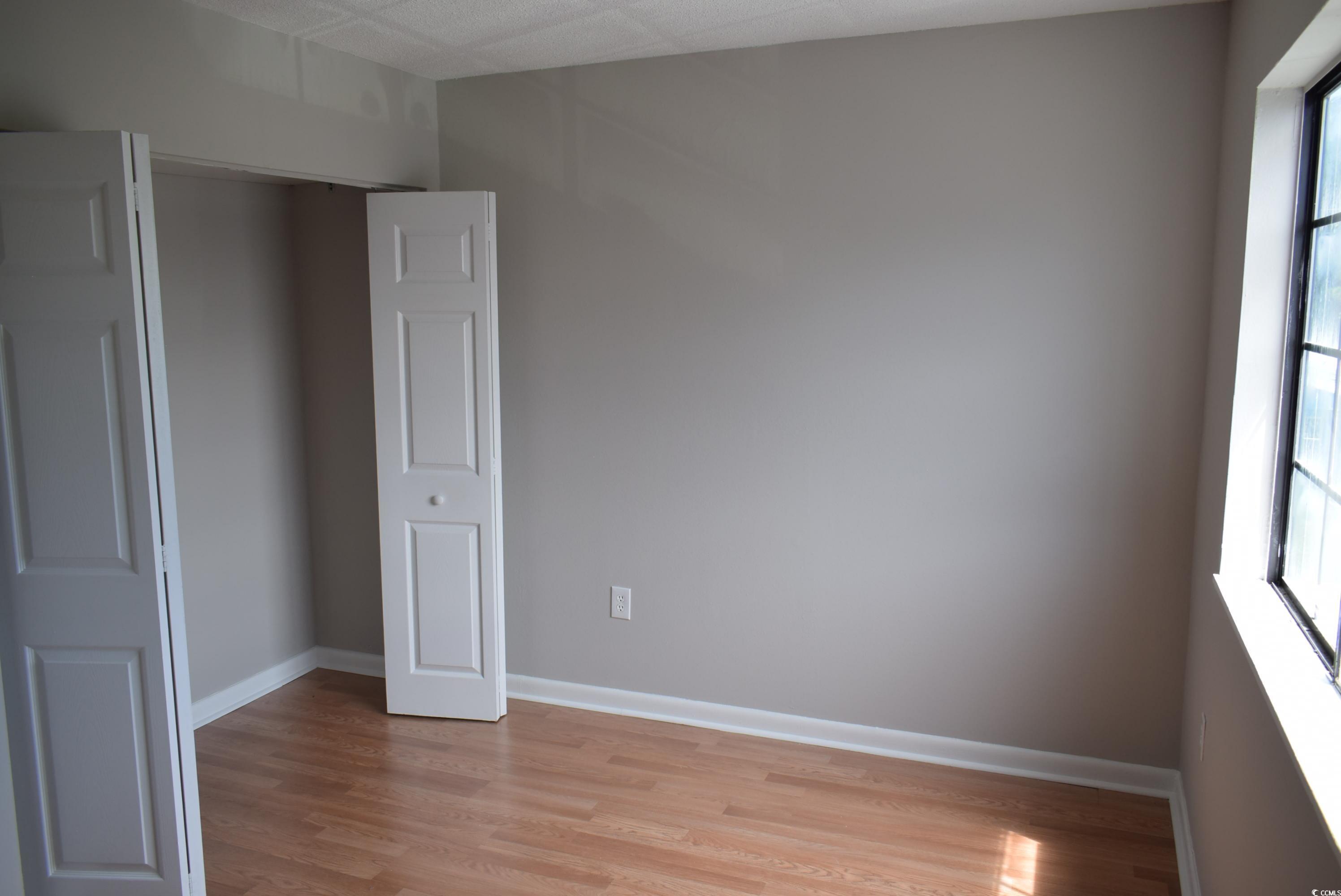 1208 Pinegrove Drive, Unit G Myrtle Beach, SC 29577 - Photo 6 of 15 Unfurnished room featuring light wood-type flooring and healthy amount of natural light