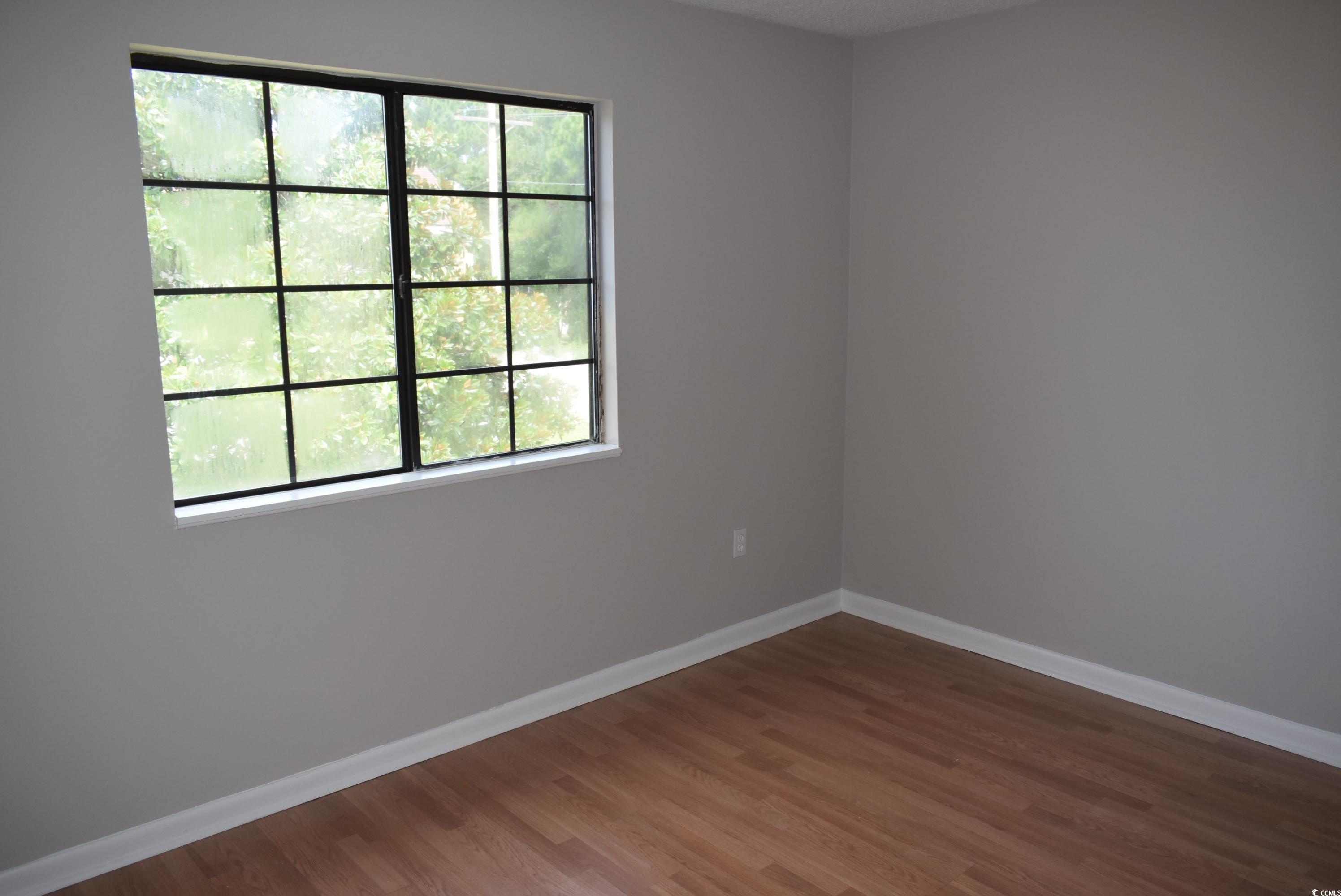 1208 Pinegrove Drive, Unit G Myrtle Beach, SC 29577 - Photo 9 of 15 Spare room featuring baseboards and wood finished floors