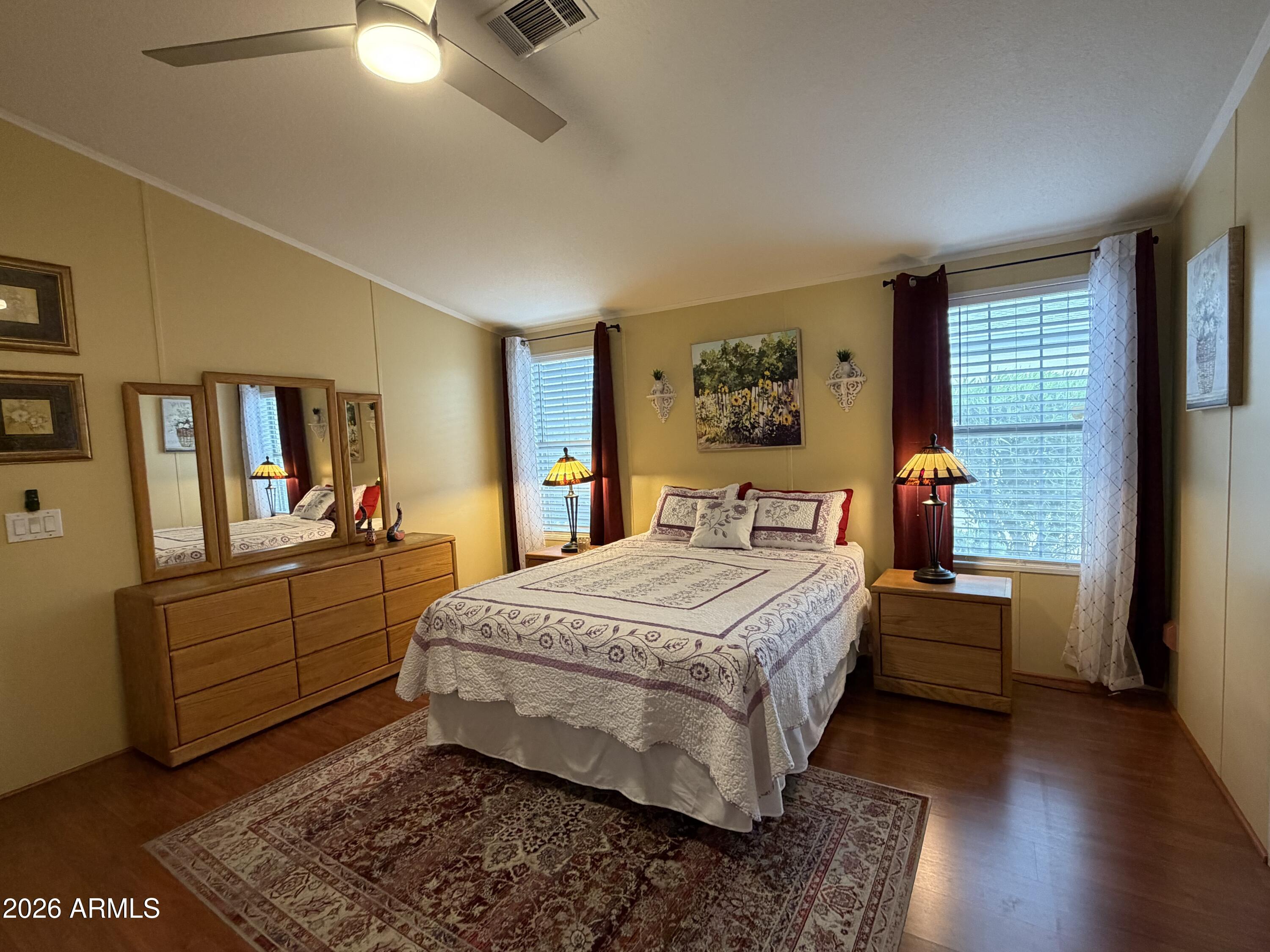 215 North Power Road, Unit 384 Mesa, AZ 85205 - Photo 11 of 27 a bedroom with a bed and wooden floor