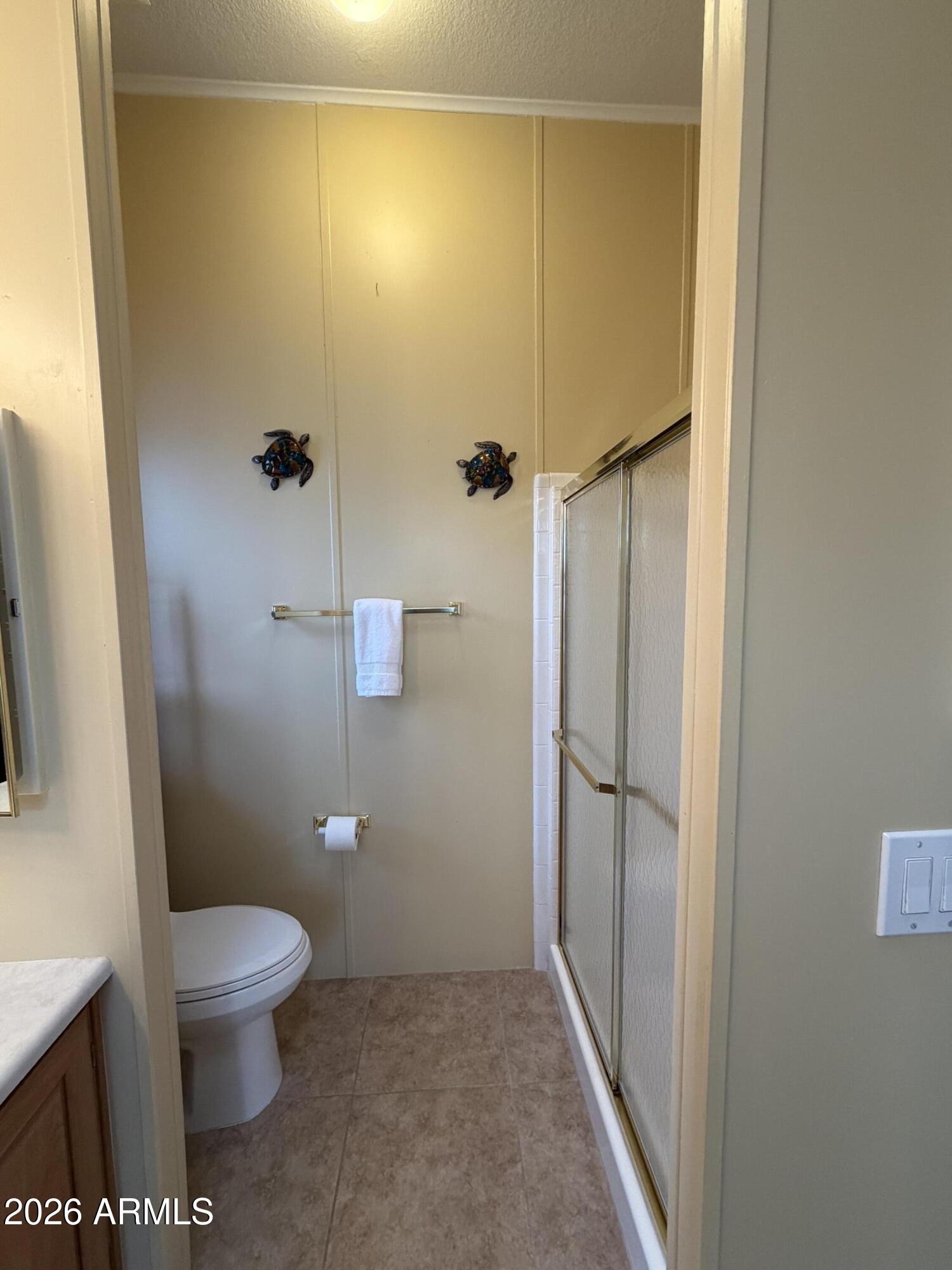 215 North Power Road, Unit 384 Mesa, AZ 85205 - Photo 14 of 27 a bathroom with a granite countertop toilet and a shower