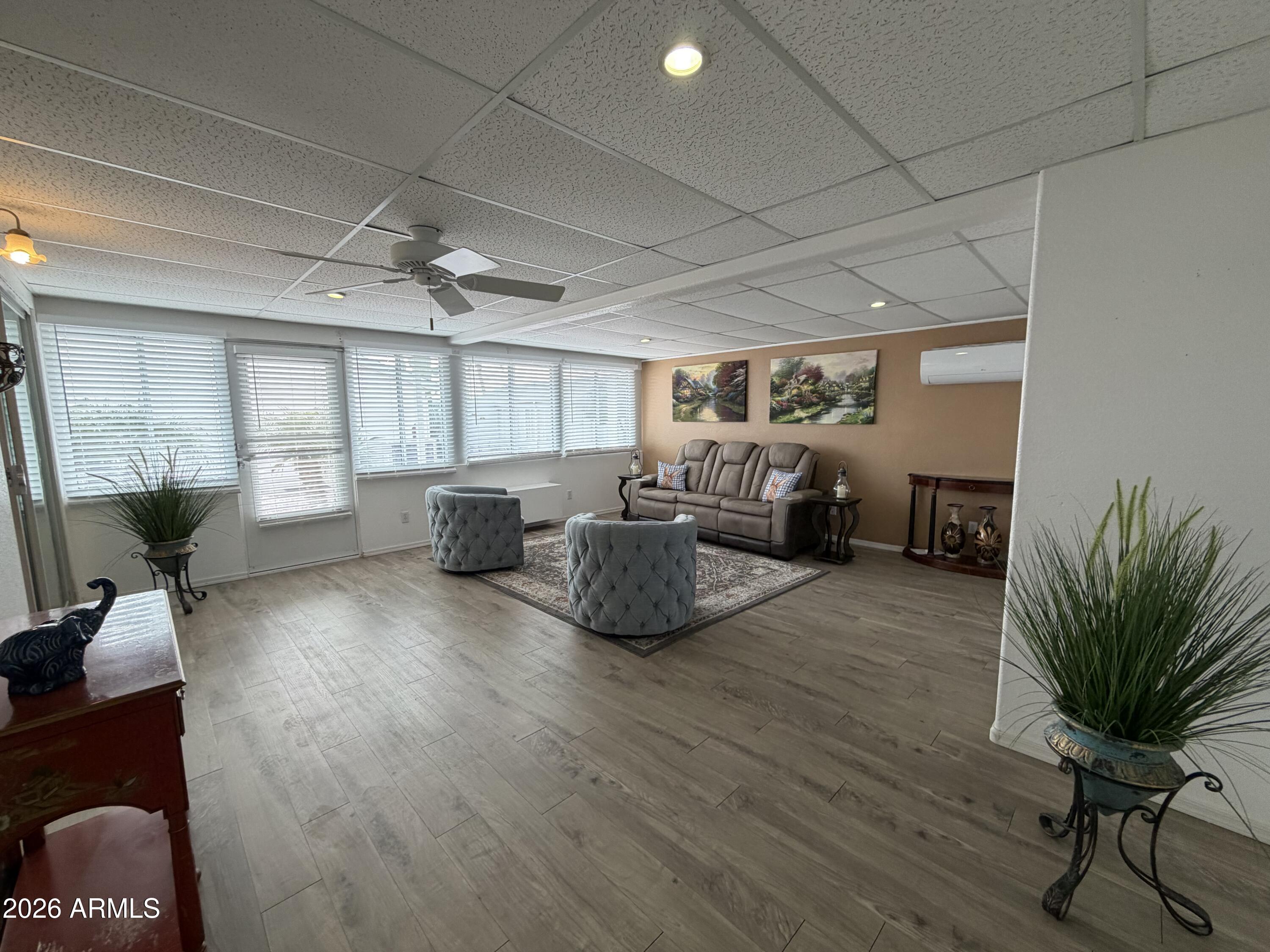 215 North Power Road, Unit 384 Mesa, AZ 85205 - Photo 20 of 27 a living room with furniture and a wooden floor