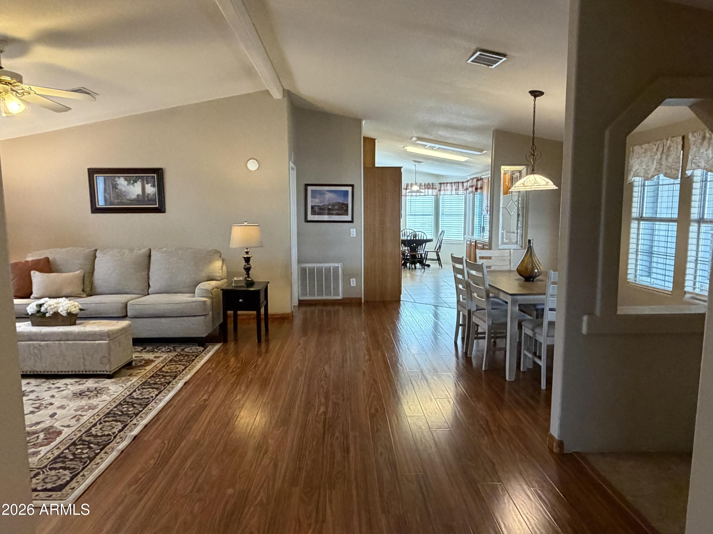 215 North Power Road, Unit 384 Mesa, AZ 85205 - Photo 2 of 27 a living room with furniture and wooden floor