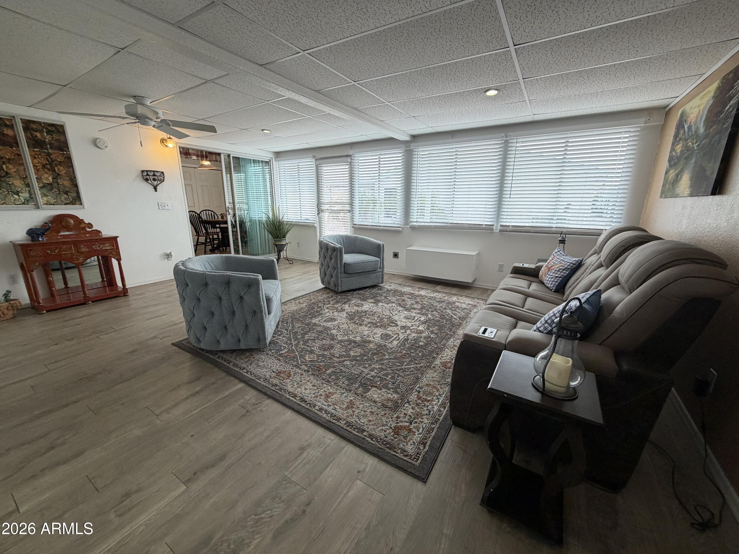 215 North Power Road, Unit 384 Mesa, AZ 85205 - Photo 22 of 27 a living room with furniture and a wooden floor