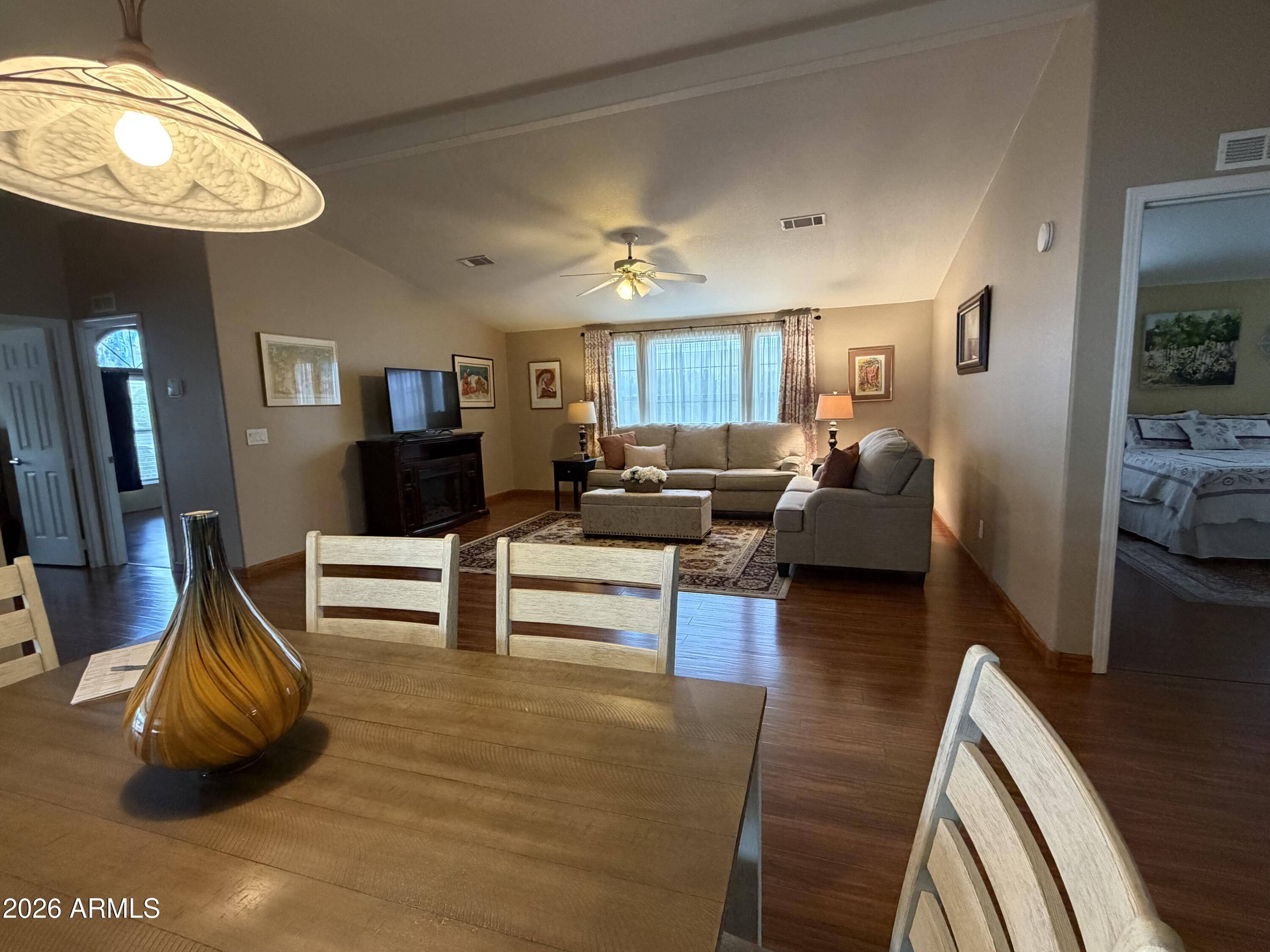 215 North Power Road, Unit 384 Mesa, AZ 85205 - Photo 4 of 27 a living room with furniture and a chandelier