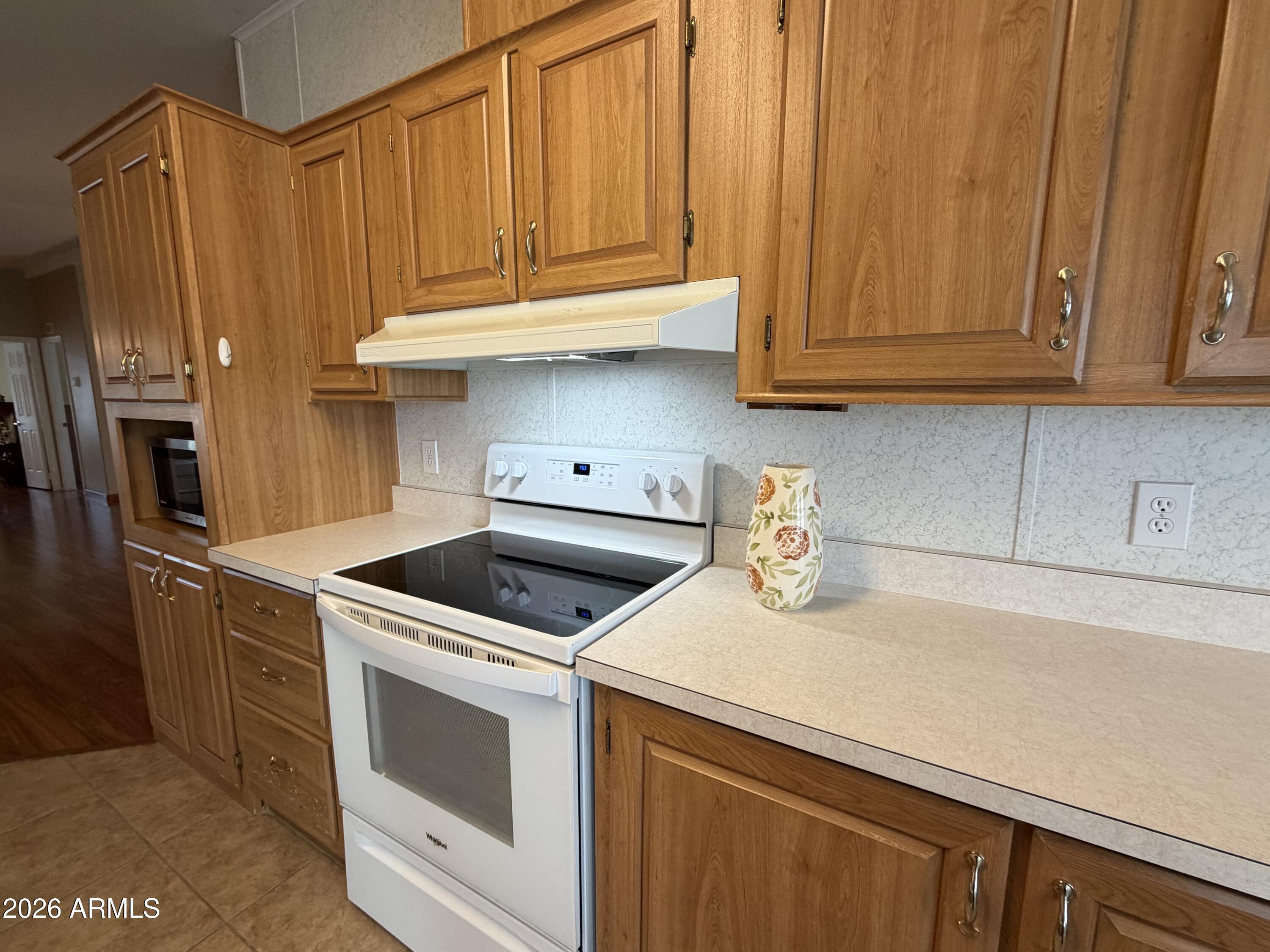215 North Power Road, Unit 384 Mesa, AZ 85205 - Photo 8 of 27 a kitchen with stainless steel appliances granite countertop a refrigerator sink and cabinets