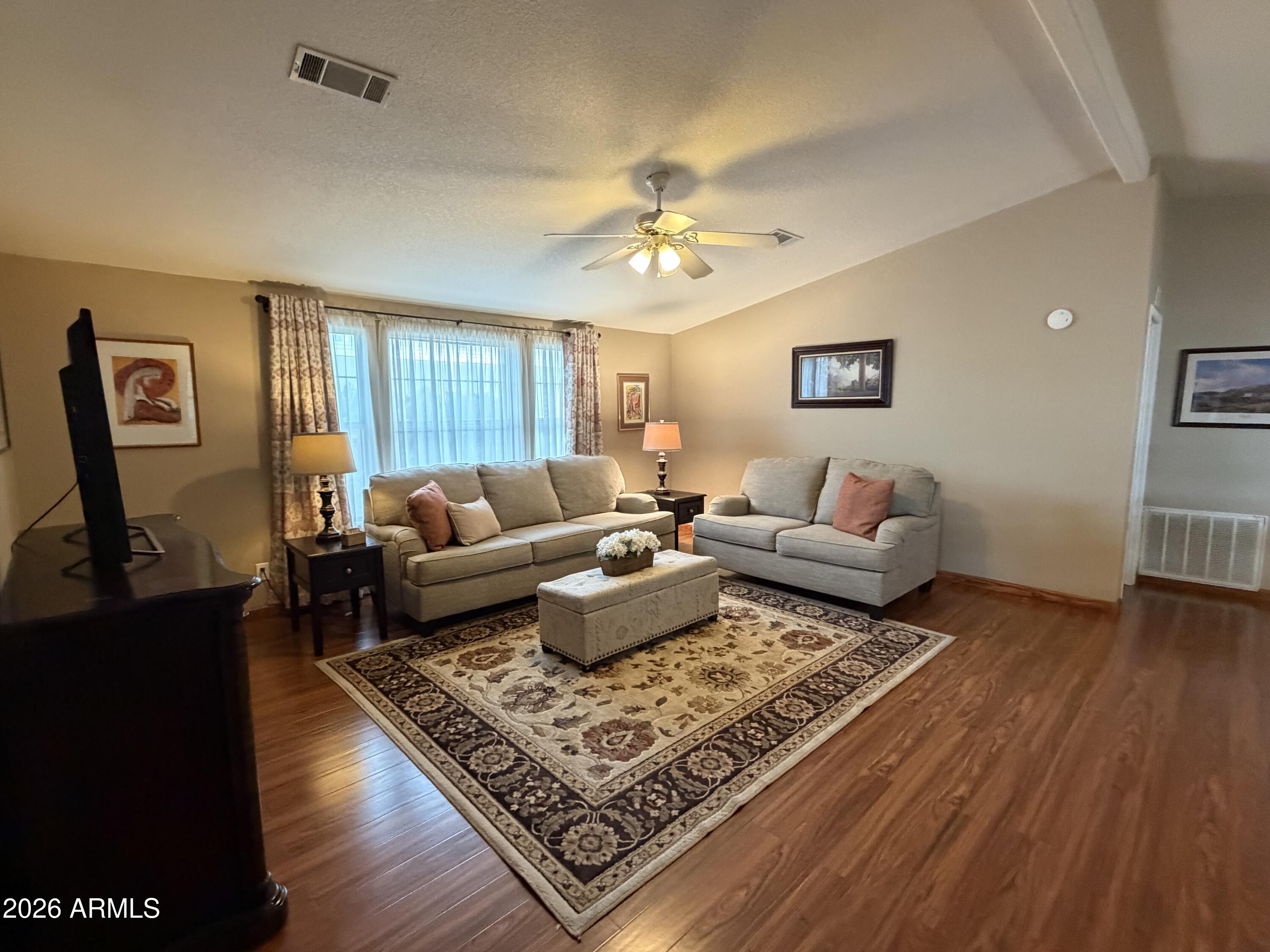 215 North Power Road, Unit 384 Mesa, AZ 85205 - Photo 9 of 27 a living room with furniture and a rug