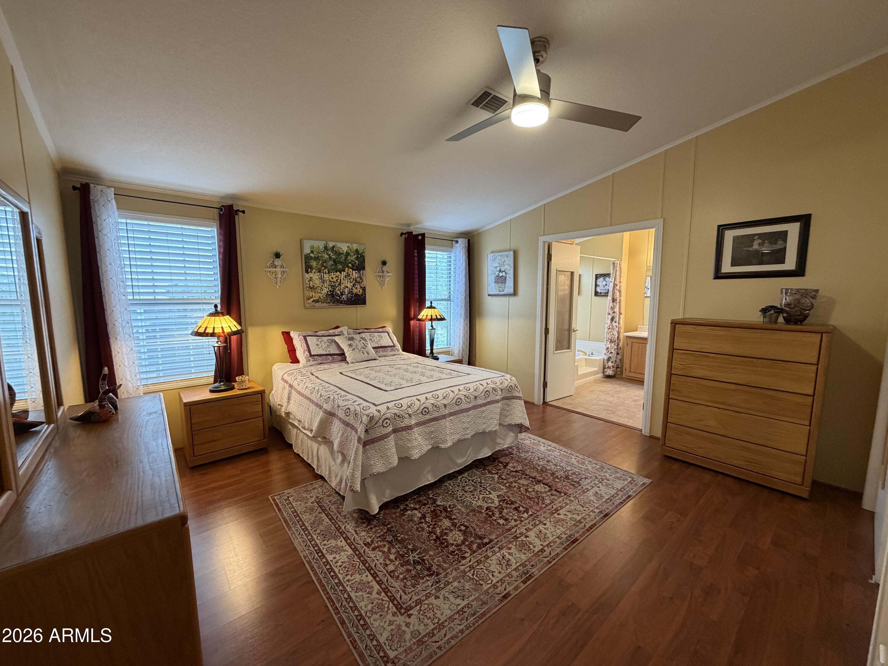 215 North Power Road, Unit 384 Mesa, AZ 85205 - Photo 10 of 27 a bedroom with a bed and wooden floor