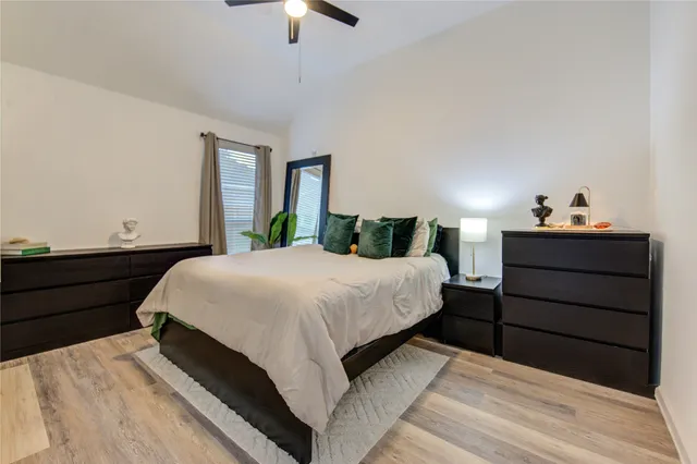 a bedroom with a bed and ceiling fan