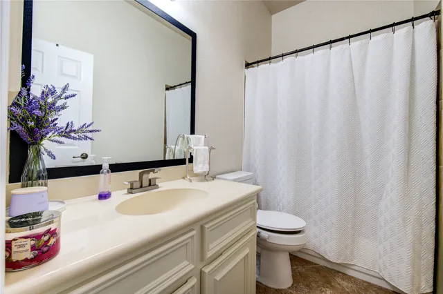 a bathroom with a sink toilet and mirror