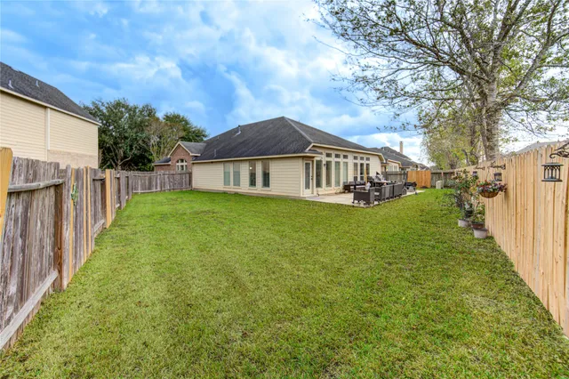 a view of a house with a yard and porch