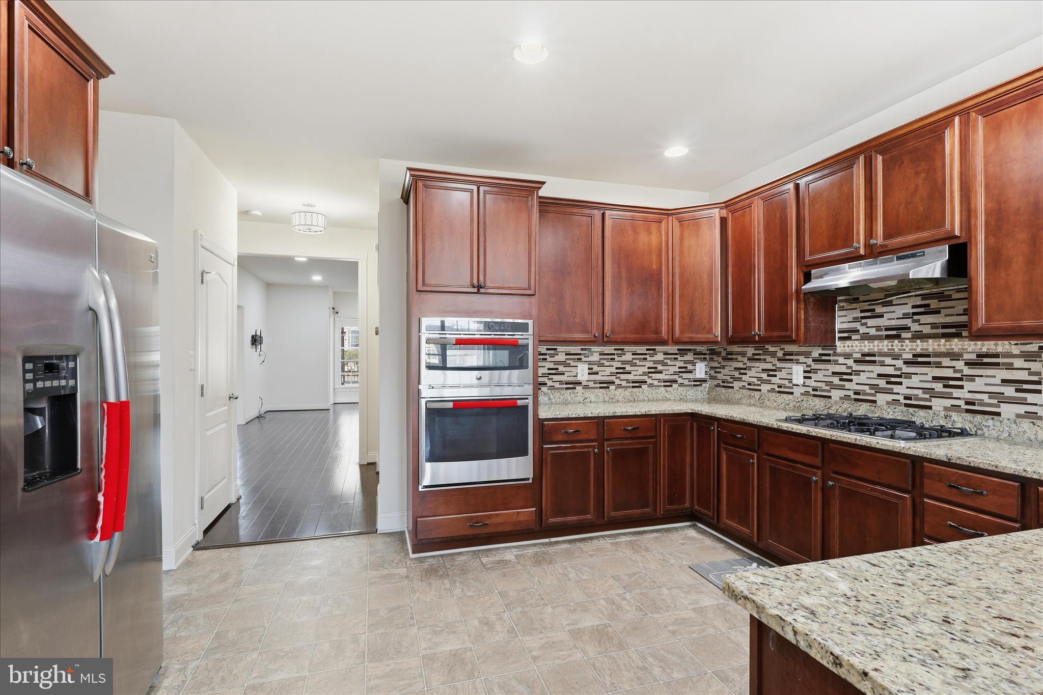 22908 North Brown Square Ashburn, VA 20148 - Photo 11 of 57 a kitchen with stainless steel appliances granite countertop a sink stove and refrigerator