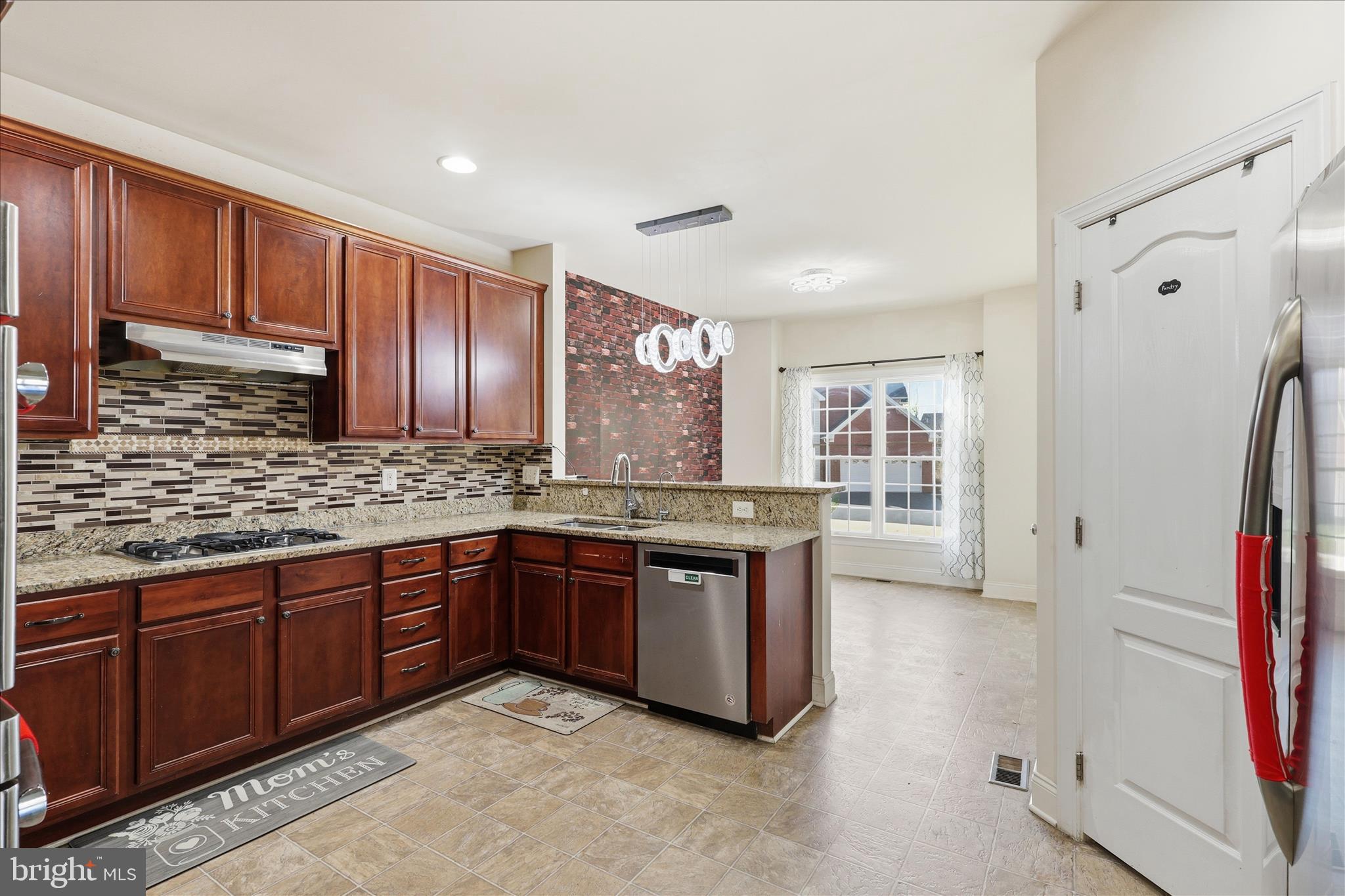 22908 North Brown Square Ashburn, VA 20148 - Photo 12 of 57 a large kitchen with stainless steel appliances granite countertop a sink and cabinets