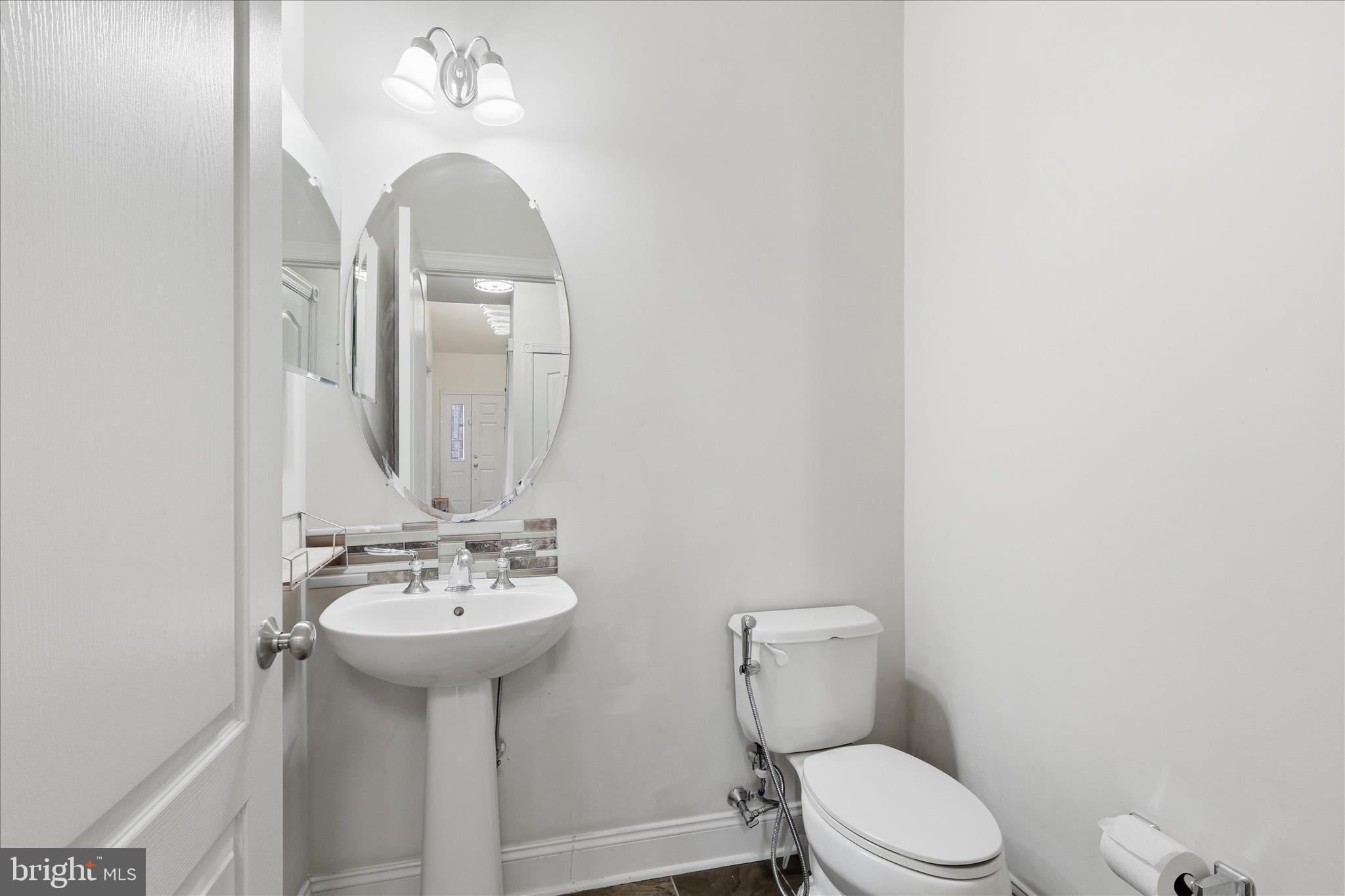 22908 North Brown Square Ashburn, VA 20148 - Photo 17 of 57 a bathroom with a toilet sink and mirror