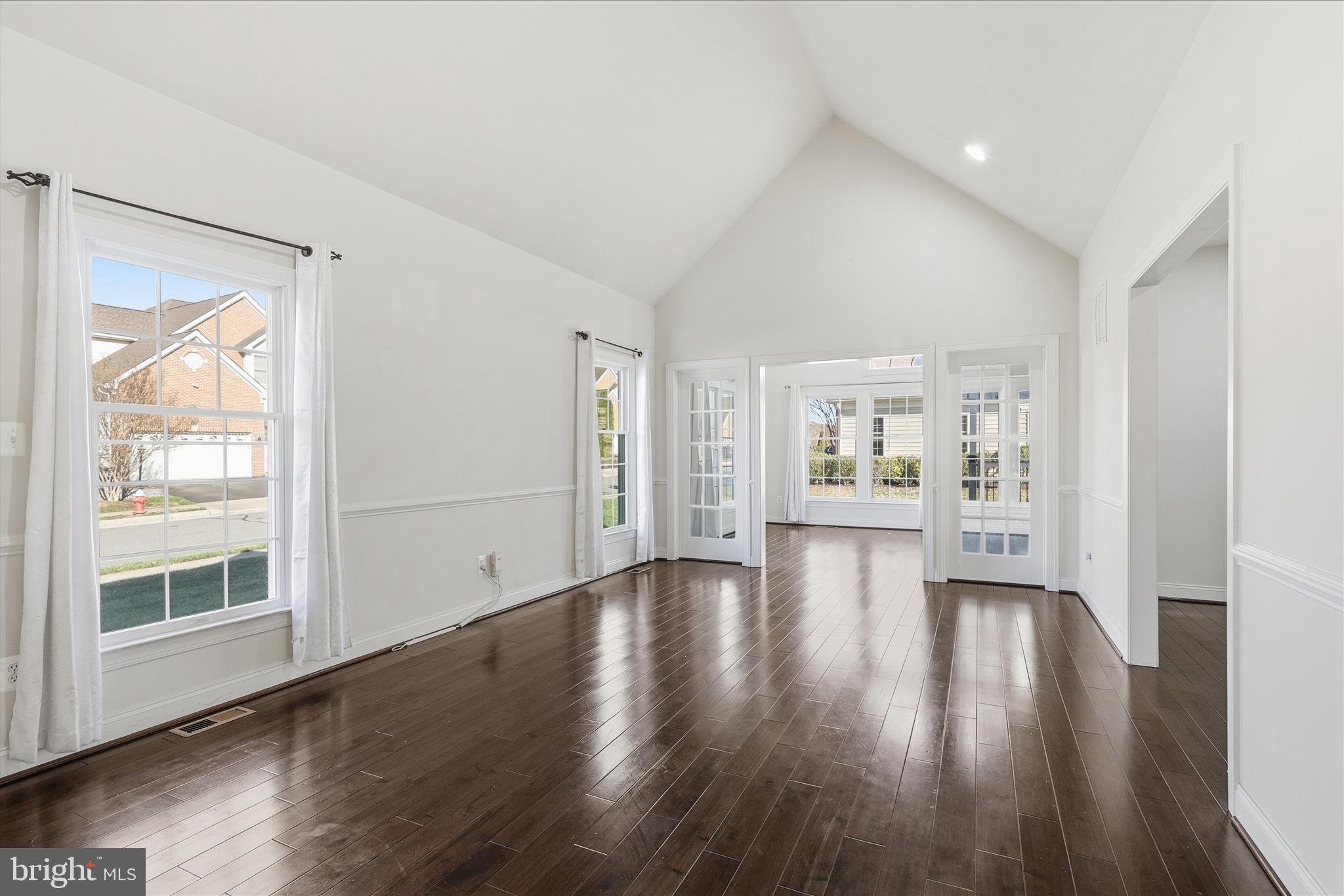 22908 North Brown Square Ashburn, VA 20148 - Photo 18 of 57 a view of an empty room with wooden floor and a window