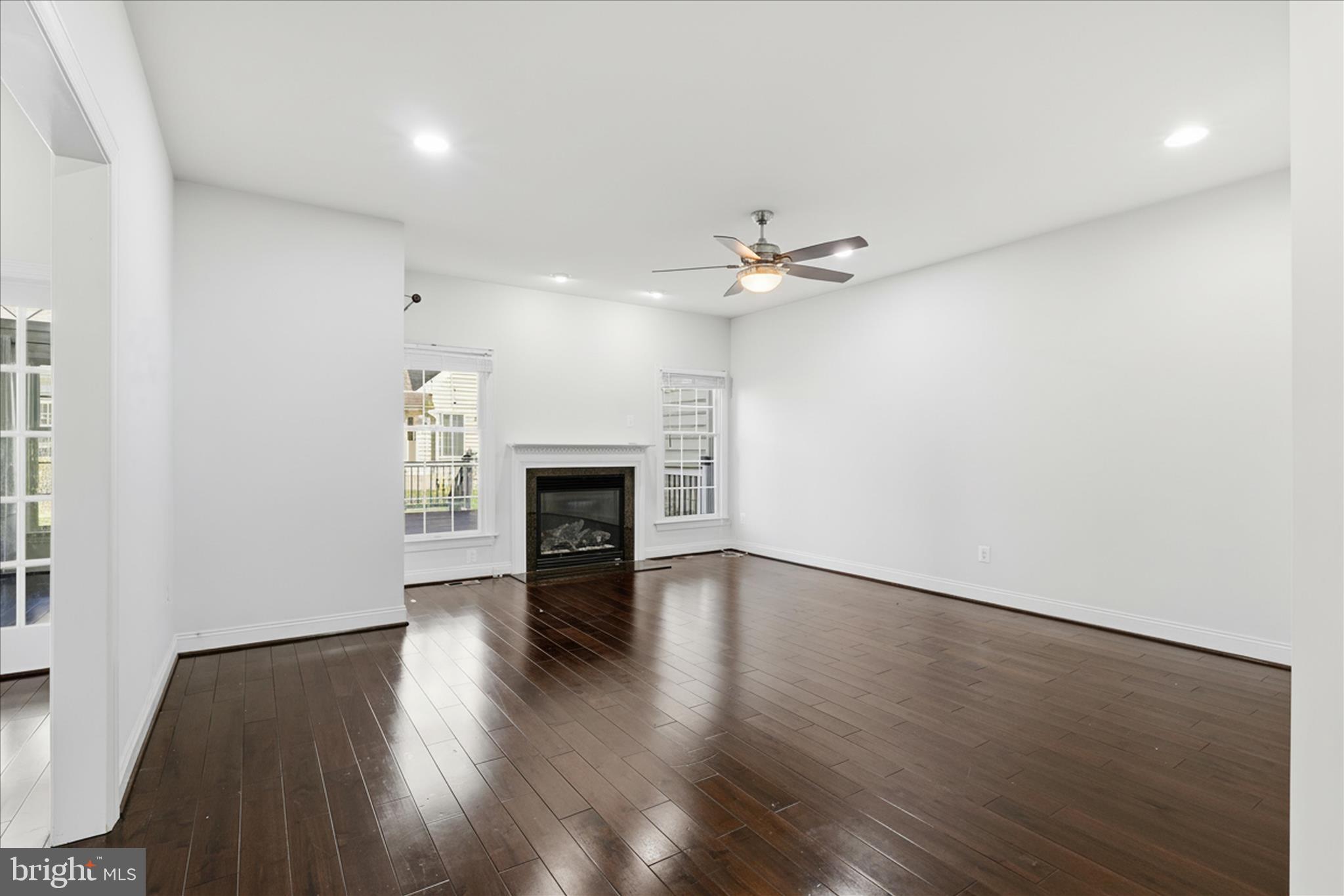 22908 North Brown Square Ashburn, VA 20148 - Photo 21 of 57 an empty room with wooden floor fireplace and windows
