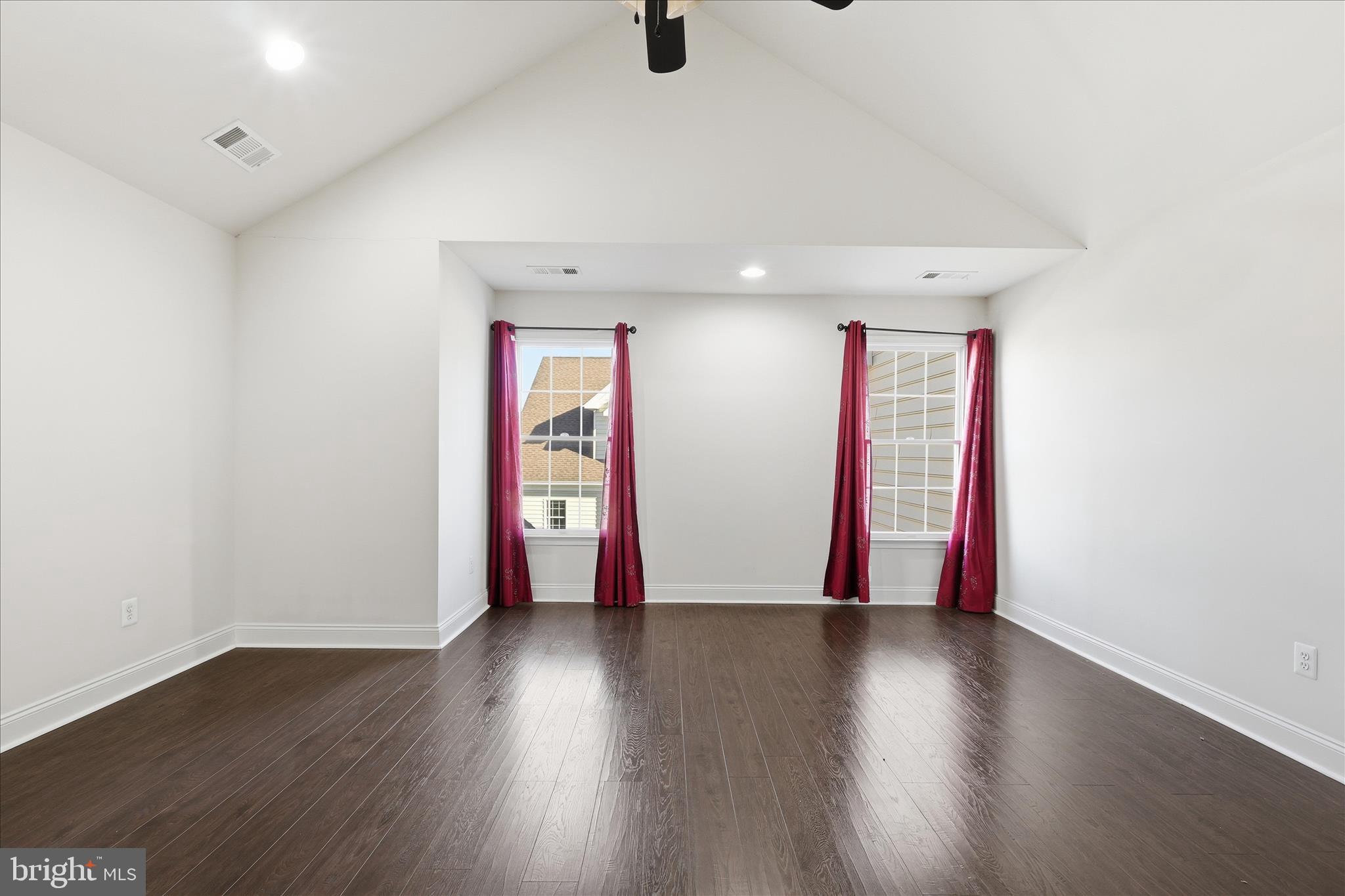 22908 North Brown Square Ashburn, VA 20148 - Photo 31 of 57 an empty room with wooden floor and windows
