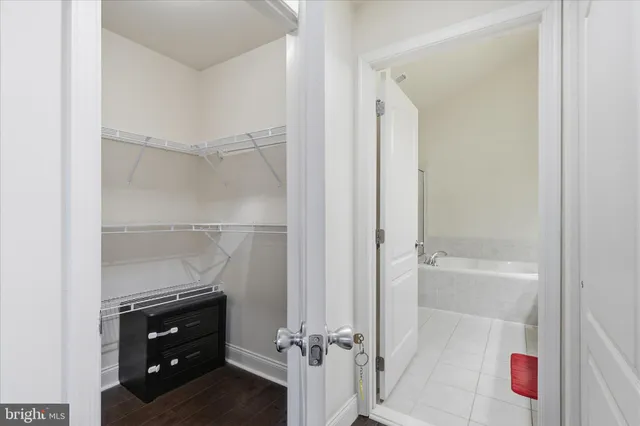 a bathroom with a tub a double vanity sink and a mirror
