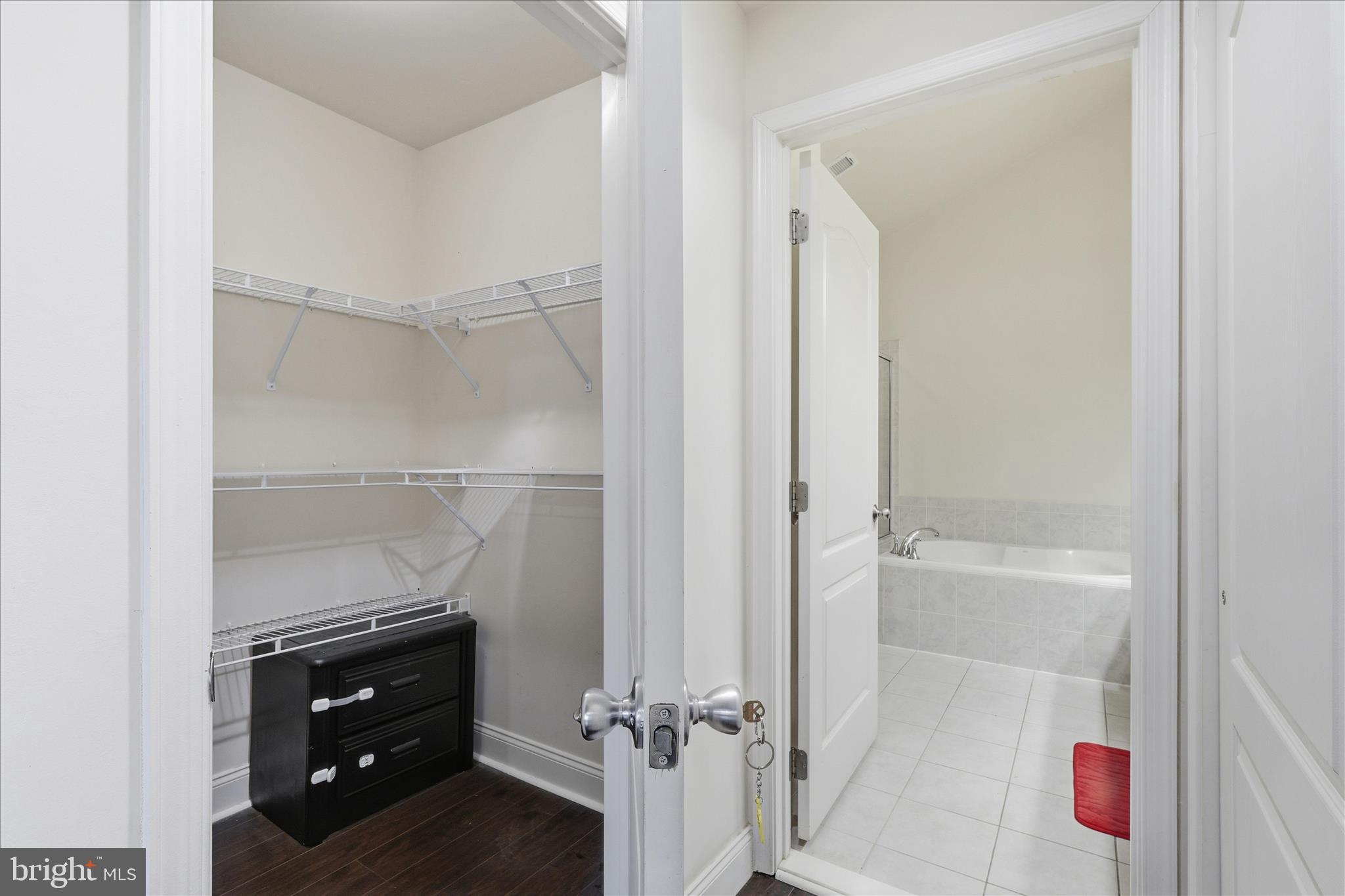 22908 North Brown Square Ashburn, VA 20148 - Photo 33 of 57 a room with a closet and a wooden floor