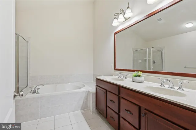 a bathroom with a tub a sink and a shower