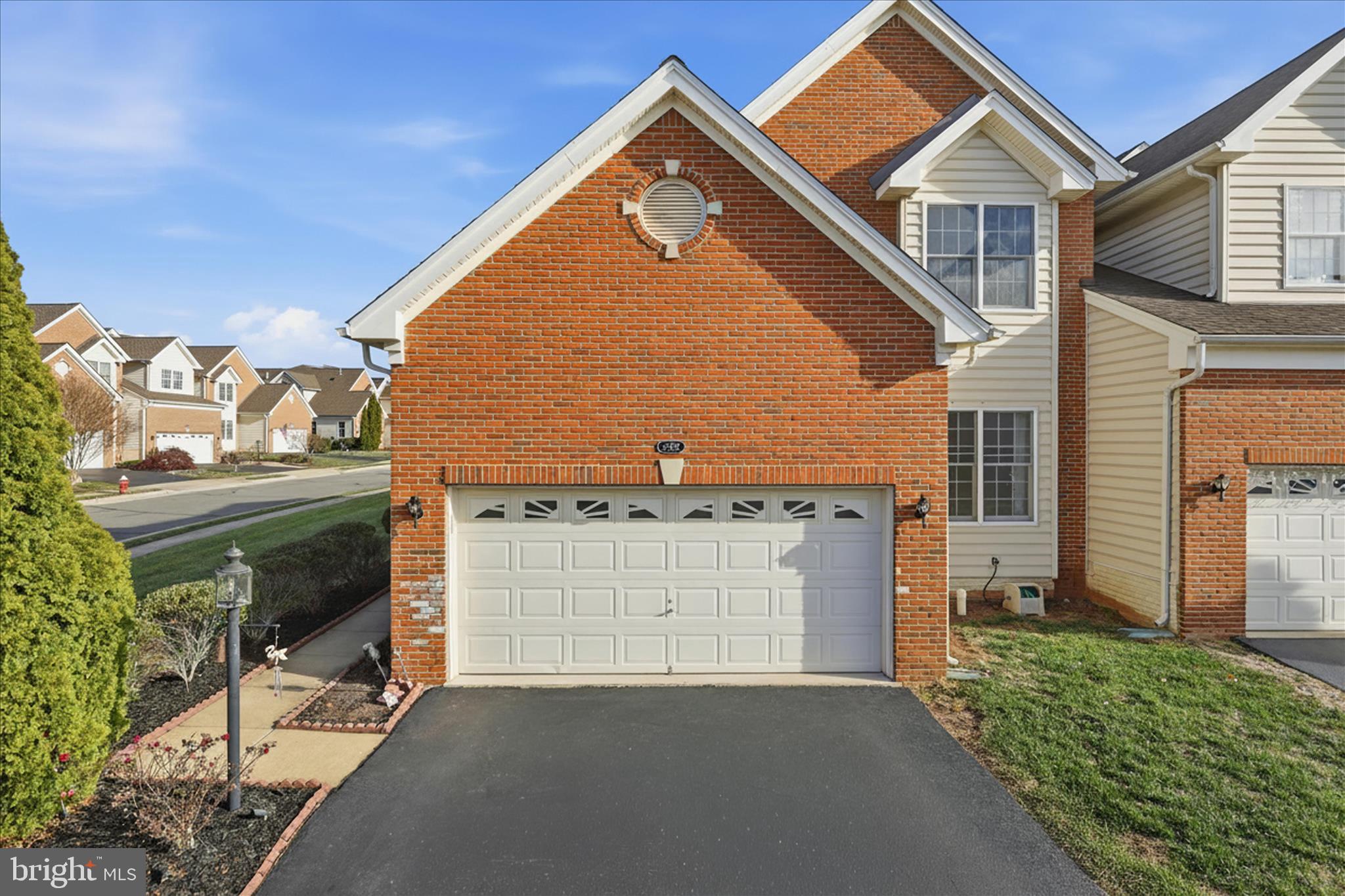 22908 North Brown Square Ashburn, VA 20148 - Photo 4 of 57 a view of a house with a yard and garage