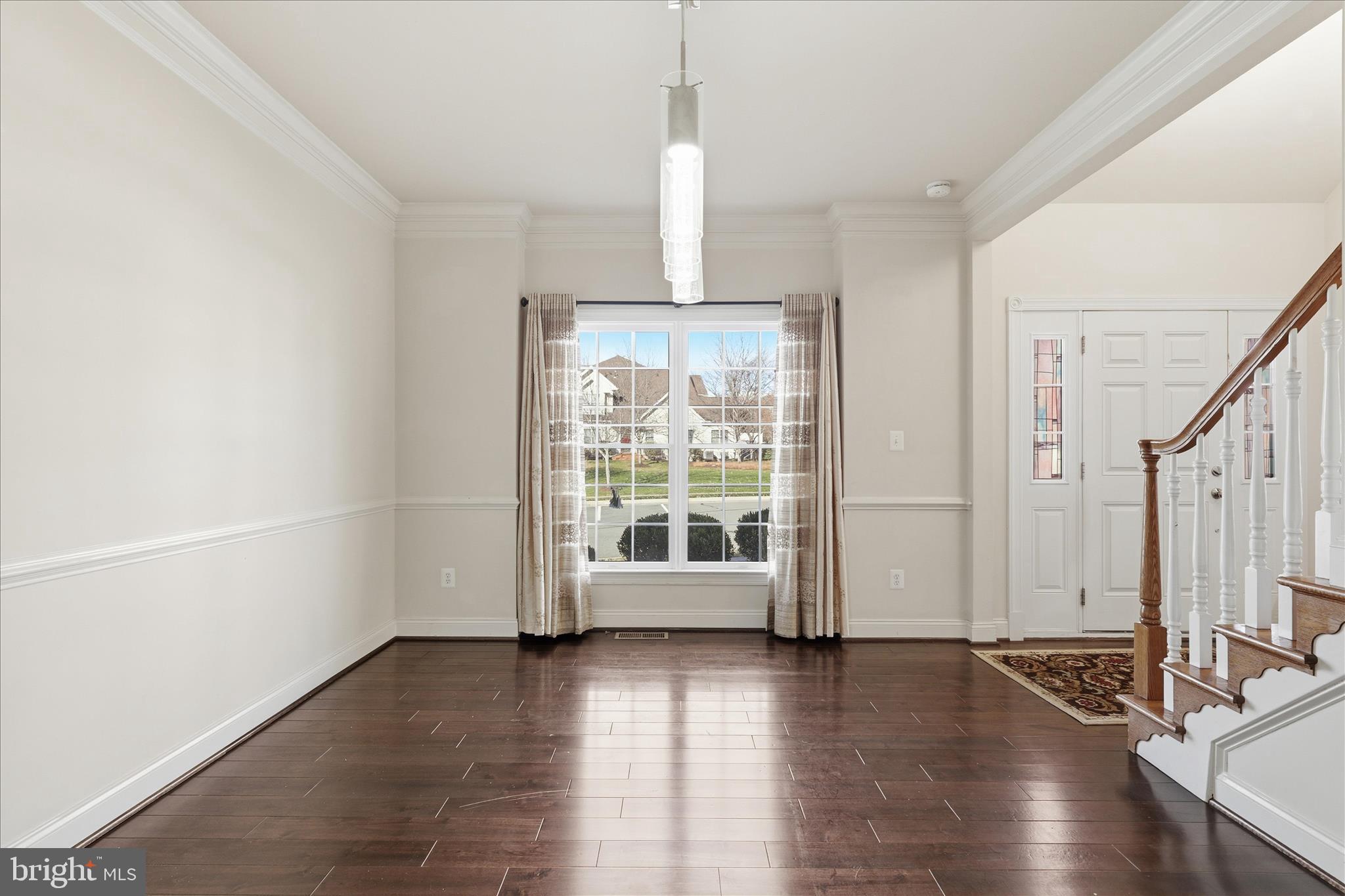 22908 North Brown Square Ashburn, VA 20148 - Photo 8 of 57 a view of an empty room with wooden floor and a window