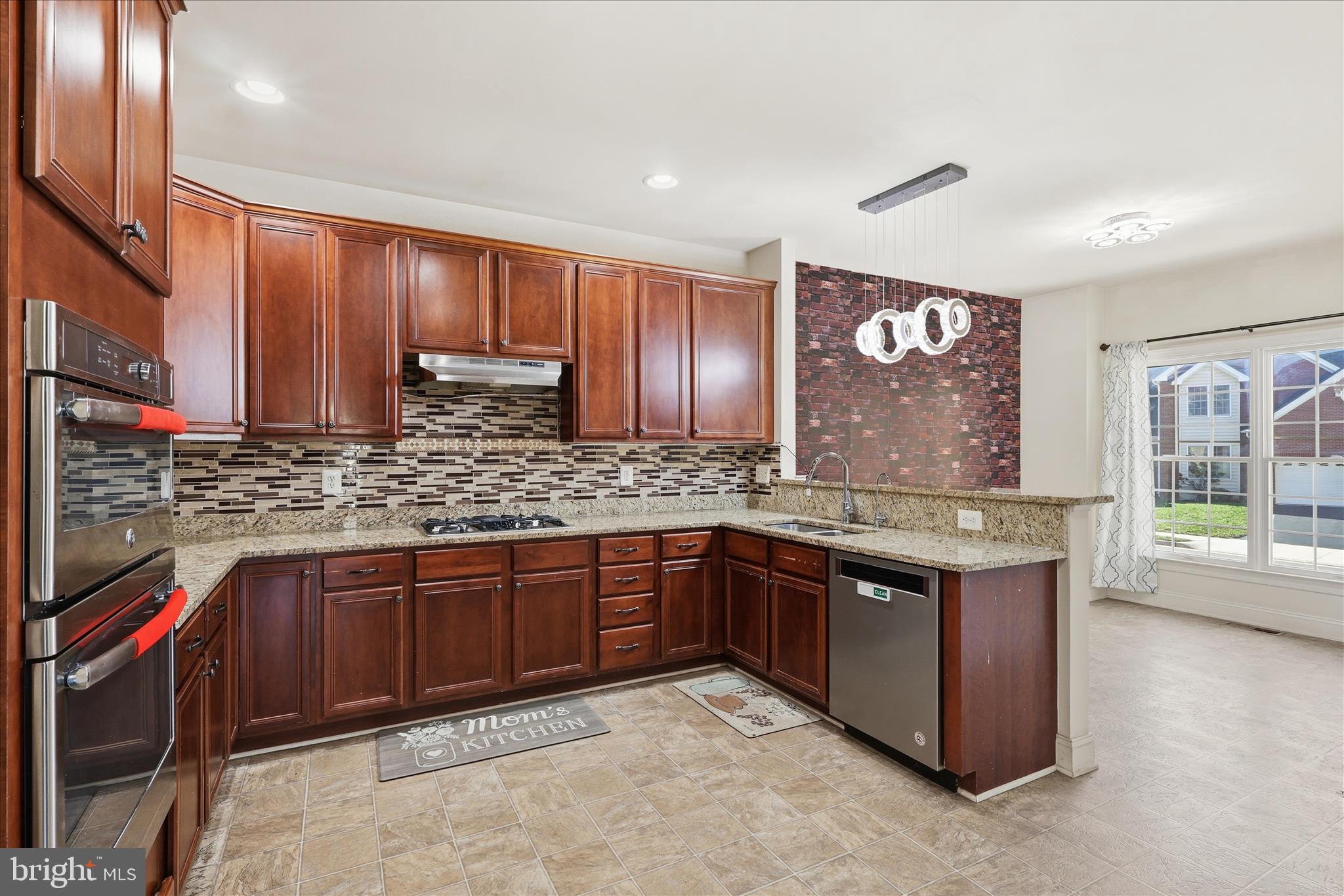 22908 North Brown Square Ashburn, VA 20148 - Photo 9 of 57 a kitchen with stainless steel appliances granite countertop wooden cabinets a sink and dishwasher