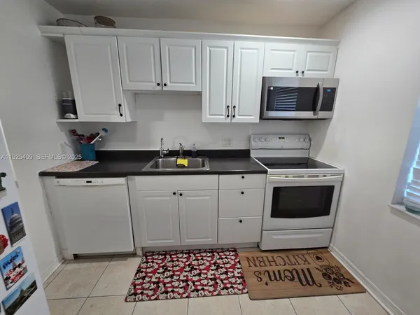 a kitchen with a sink stove and microwave