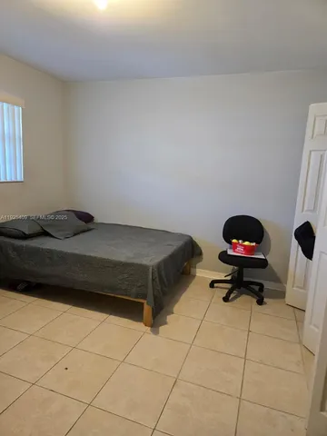 a bedroom with a bed and a stove