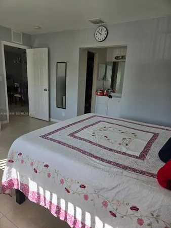 a bedroom with a bed and a mirror