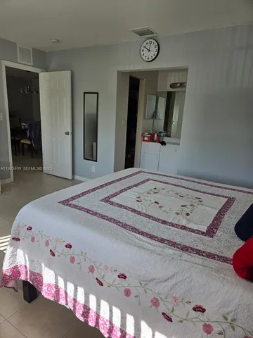 a bedroom with a bed and a mirror