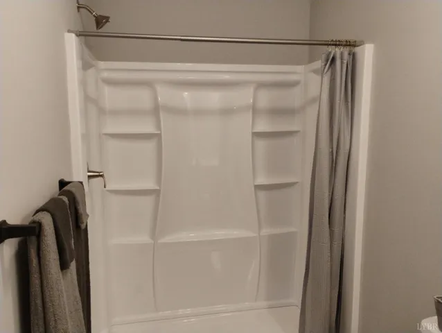 a view of room with furniture and wooden floor