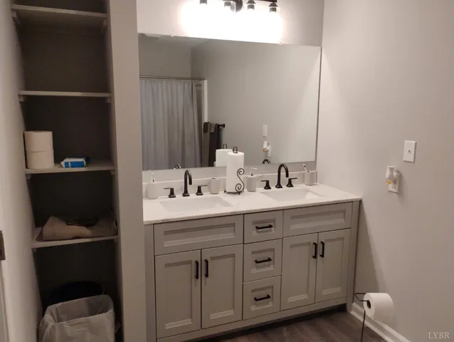 an empty room with a ceiling fan and wooden floor