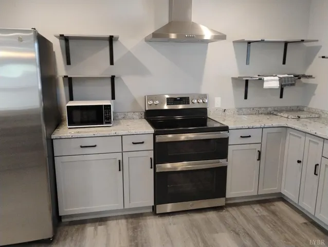 a stove top oven sitting inside of a kitchen