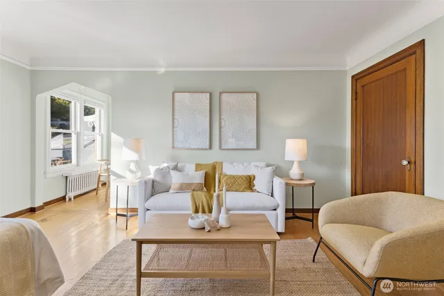 a living room with furniture and wooden floor