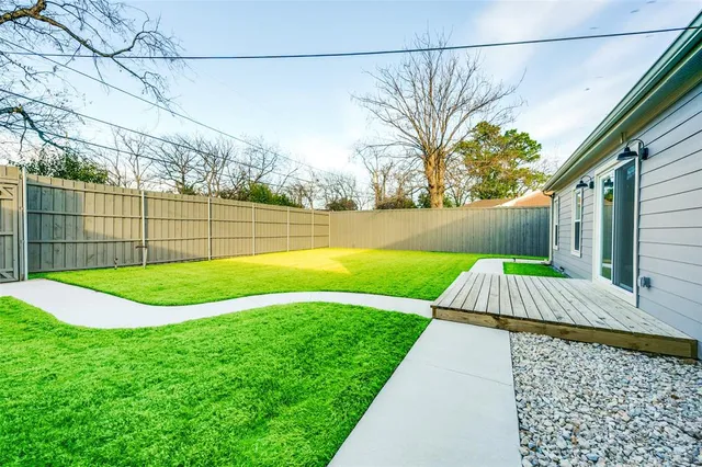 a view of backyard with trampoline