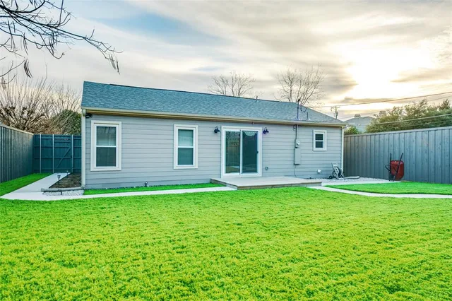 a backyard of a house with table and chairs