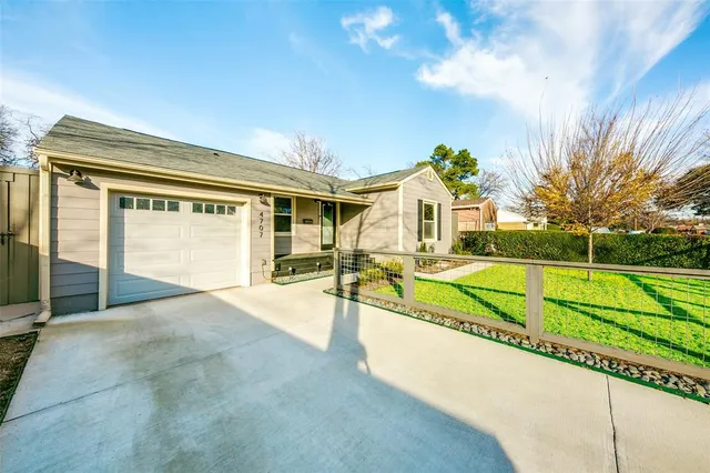 a view of an house with backyard and a tree