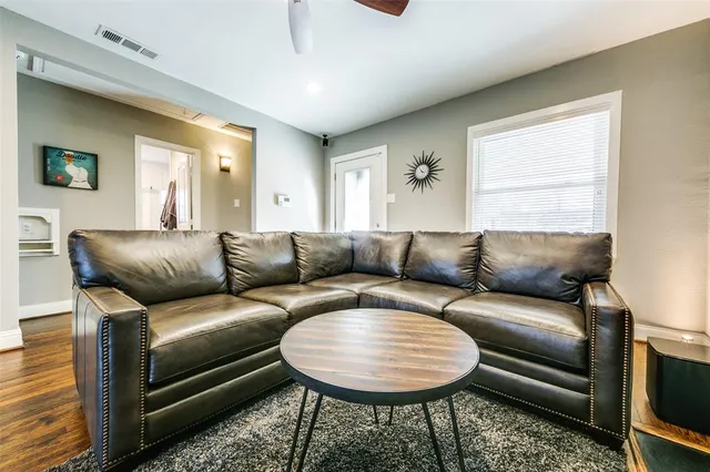 a living room with a couch and a bookshelf