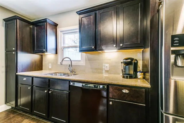 a kitchen with stainless steel appliances a sink and cabinets