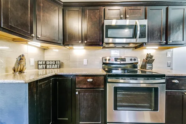 a kitchen with stainless steel appliances a stove and a microwave