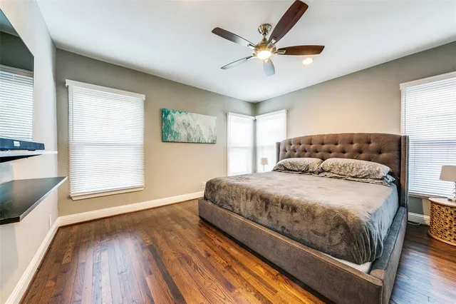a bedroom with a large bed and a large window