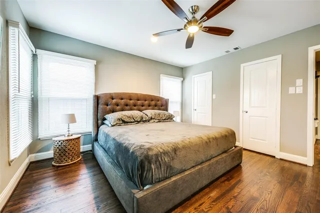 a bedroom with a bed and a ceiling fan
