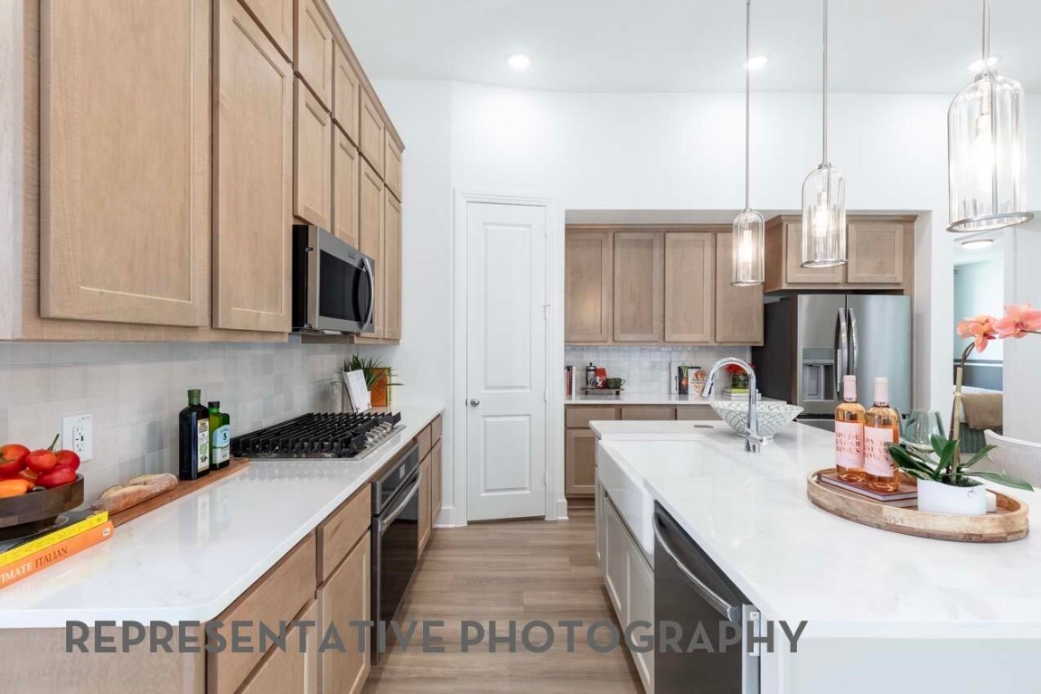 5331 Murillo Drive Manvel, TX 77578 - Photo 8 of 20 a kitchen with a sink stove and cabinets