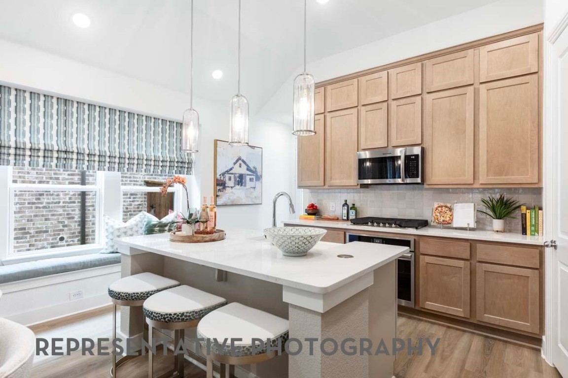 5331 Murillo Drive Manvel, TX 77578 - Photo 9 of 20 a kitchen with a sink stove and white cabinets