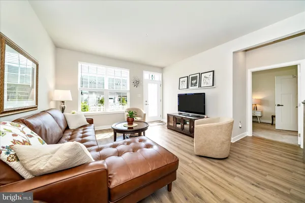 a living room with furniture and a lamp